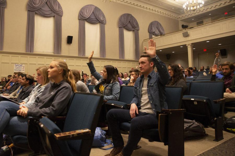 Students raise their hands during an all-student assembly, held to address growing concerns surrounding food and housing insecurity among UK students, in Memorial Hall in Lexington, Ky., on March 21, 2019. Photo by Rick Childress | Staff