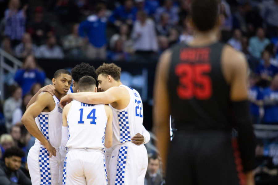 UK huddles up before the start of the game while freshman guard Keldon Johnson stares down a Houston player. University of Kentucky mens basketball team narrowly defeated University of Houston 62-58 in the Sweet 16 of the NCAA Tournament at the Sprint Center on Friday, March 29, 2019 in Kansas City, Missouri. Photo by Michael Clubb | Staff