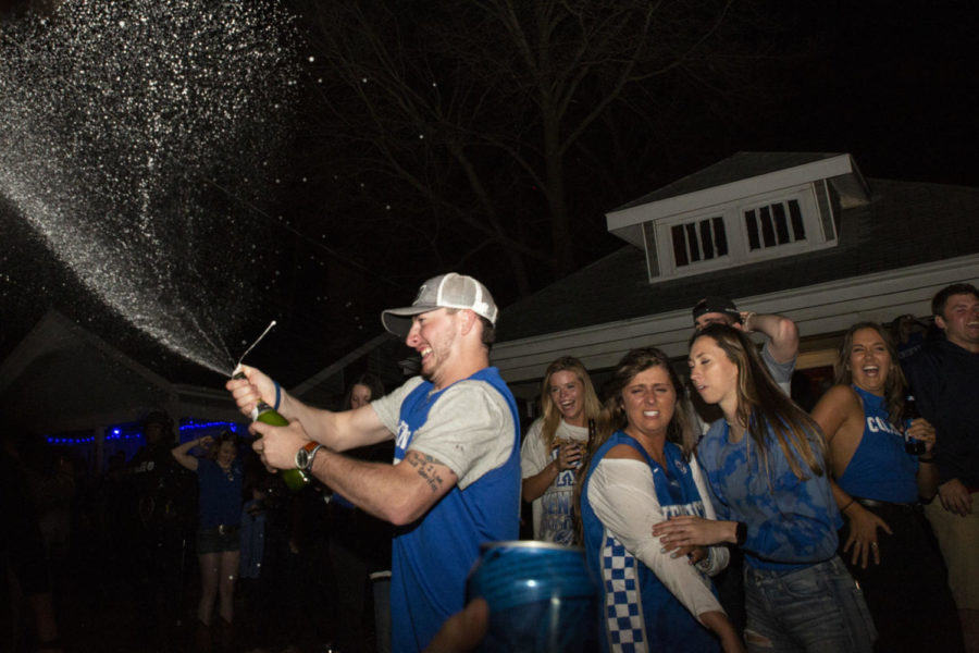 A+Kentucky+fan+opens+a+bottle+of+champagne+in+celebration+on+State+Street+after+Kentuckys+Sweet+Sixteen+win+against+Houston+on+Friday%2C+March+29%2C+2019%2C+in+Lexington%2C+Kentucky.+Kentucky+defeated+Houston+62-58%2C+pushing+Kentucky+into+the+Elite+Eight+game+against+Auburn.+Photo+by+Arden+Barnes+%7C+Staff
