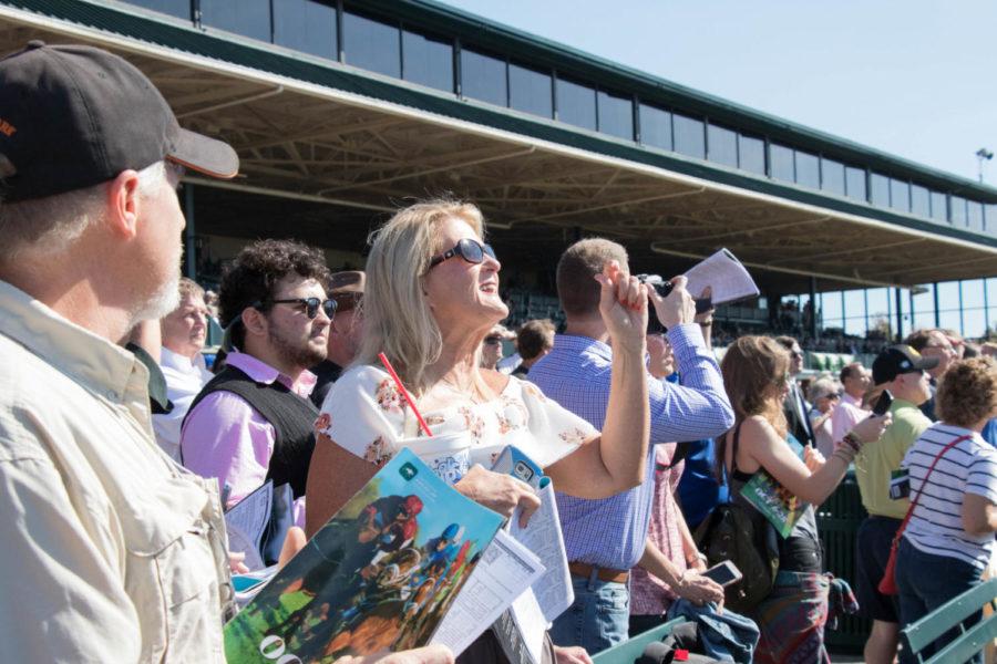 A fan cheering on for her pick of the race to win on College Scholarship Day at Keeneland on Friday, October 20, 2017 in Lexington , Kentucky. Photo By Genna Melendez | Staff