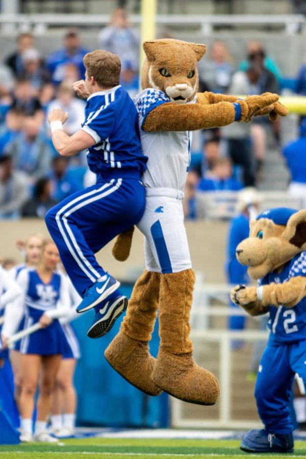 A UK cheerleader jumps up with the UK mascot before the game. University of Kentucky’s football team played their annual spring game on Friday, April 12, 2019 at Kroger Field. The Blue team won 64-10. Photo by Michael Clubb | Staff