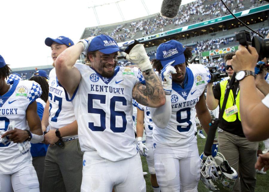Kentucky Wildcats linebacker Kash Daniel and safety Davonte Robinson adjust their Citrus Bowl champions hats during the VRBO Citrus Bowl against Penn State on Tuesday, Jan. 1, 2019, at Camping World Stadium, in Orlando, Florida. Kentucky defeated Penn State 27-24. Photo by Arden Barnes | Staff