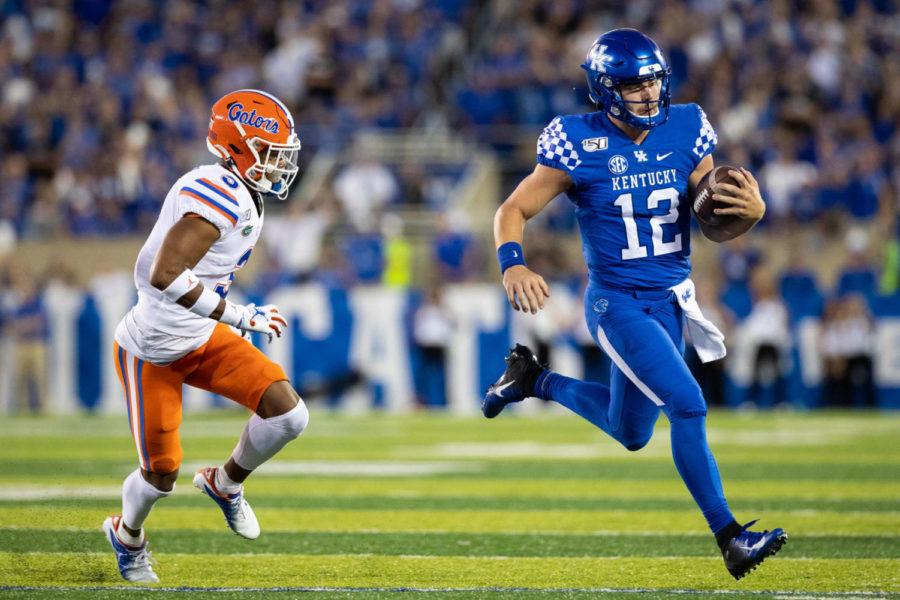Kentucky Wildcats quarterback Sawyer Smith (12) runs the ball out of bounds during the UK vs Florida football game on Saturday, Sept. 14, 2019, at the University of Kentucky in Lexington, Kentucky. Florida won 29-21. Photo by Michael Clubb | Staff