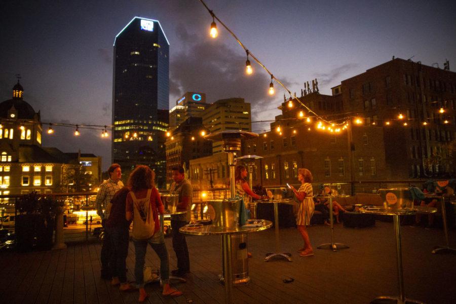 Bar-goers visit and enjoy drinks on the rooftop at Belles Cocktail House on Friday, September 6, 2019, in downtown Lexington, Ky. Photo by Arden Barnes | Staff