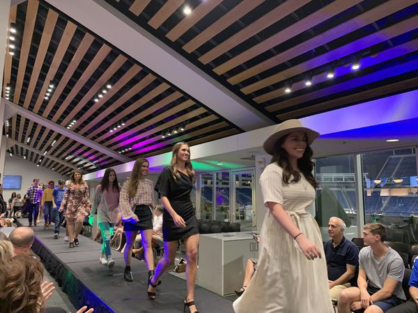 Members of the UK College of Dentistry walk down the runway during the American Association of Women Dentists' 13th annual 'Strut Your Smile' fashion show at Kroger Field on Sept. 20, 2019. Proceeds for the event go toward helping Greenhouse17, a local shelter for those affected by domestic violence. Photo by Haley Blackburn