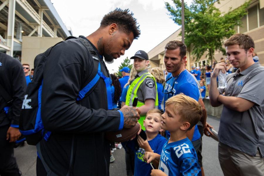 Kentucky Wildcats wide receiver Lynn Bowden Jr. autographs a football for young fans during Cat Walk before the game against Eastern Michigan on Saturday, Sept. 7, 2019, at Kroger Field in Lexington, Kentucky. Photo by Jordan Prather | Staff