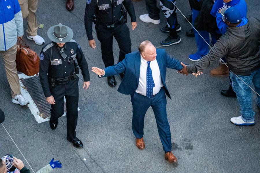 Kentucky Wildcats head coach Mark Stoops high fives a fan during. Cat Walk before the Kentucky vs. Tennessee football game on Saturday, Nov. 9, 2019, at Kroger Field in Lexington, Kentucky. UK lost 17-13. Photo by Michael Clubb | Staff