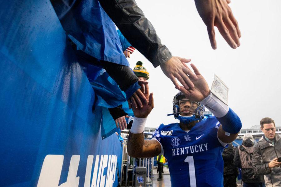Kentucky Wildcats quarterback Lynn Bowden Jr. (1) high fives fans after the University of Kentucky vs. University of Louisville Governor’s Cup football game on Saturday, Nov. 30, 2019, at Kroger Field in Lexington, Kentucky. UK won 45-13. Photo by Michael Clubb | Staff