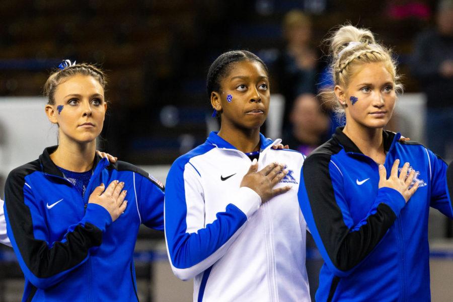 Members of the Kentucky gymnastics team stand for the playing of the national anthem before the Blue/White meet on Sunday, Dec. 15, 2019, at Memorial Coliseum in Lexington, Kentucky. Photo by Jordan Prather | Staff