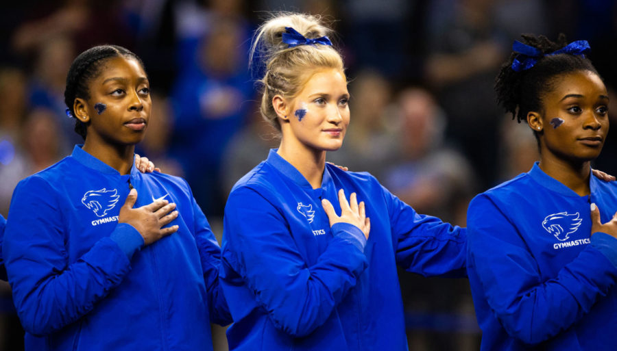 Kentucky sophomore Cally Nixon, freshman Elyssa Roberts and sophomore Arianna Patterson stand for the national anthem before the meet on Friday, Jan. 17, 2020, at Memorial Coliseum in Lexington, Kentucky. Photo by Jordan Prather | Staff