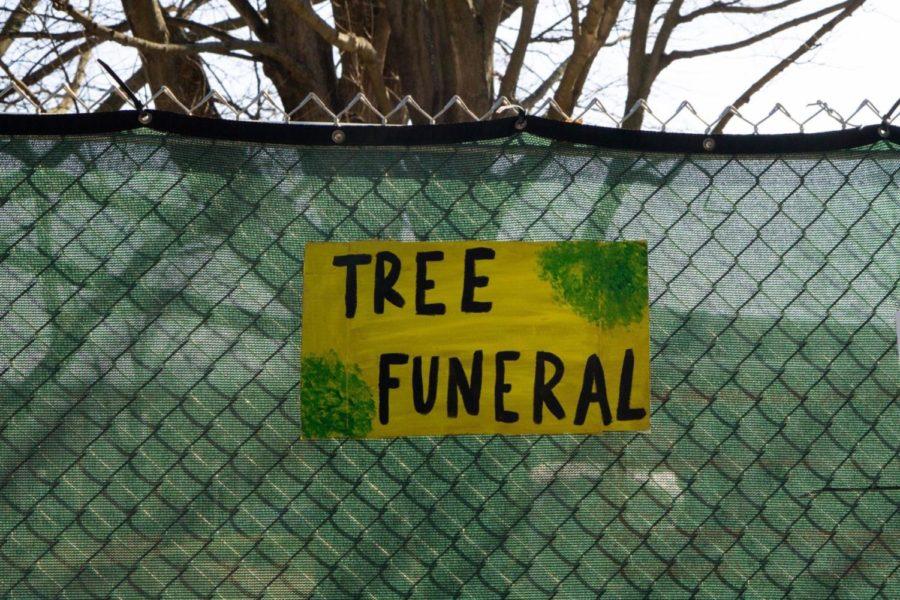 A sign at the tree funeral on Feb. 21, 2020, hangs on a fence that surrounds the Kirwan-Blanding Construction Complex. Photo provided by Kelly Walker.