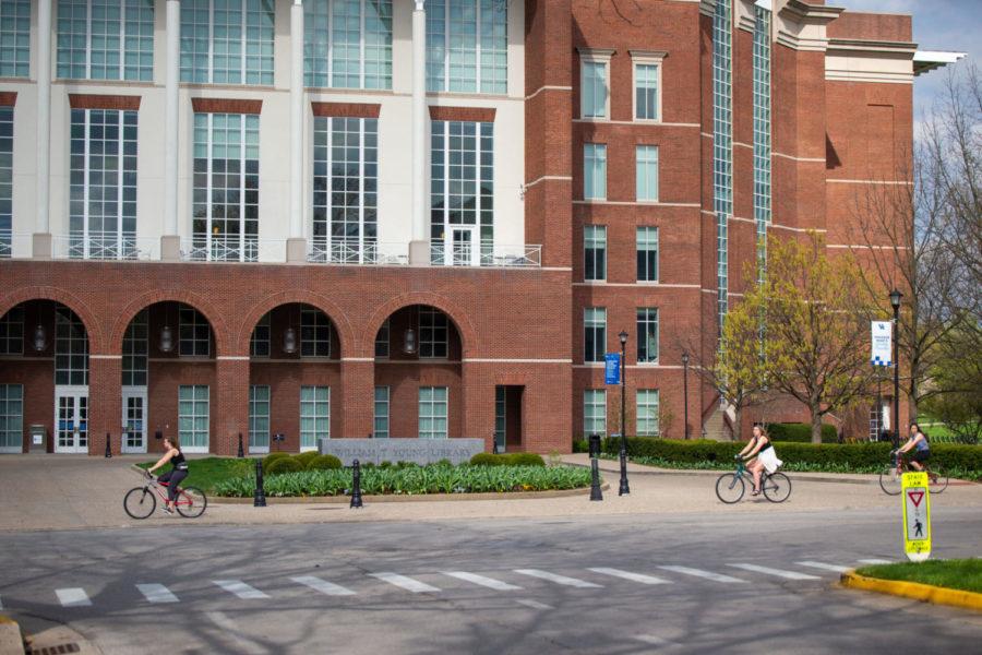 Bikers pass the William T. Young Library on Monday, April 6, 2020, at the University of Kentucky in Lexington, Kentucky. Photo by Jordan Prather | Staff