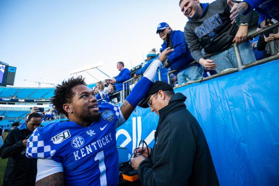 Kentucky Wildcats quarterback Lynn Bowden Jr. (1) high fives fans after the Belk Bowl football game between Kentucky and Virginia Tech on Tuesday, Dec. 31, 2019, at Bank of America Stadium in Charlotte, North Carolina. UK won 37-30. Photo by Michael Clubb | Staff