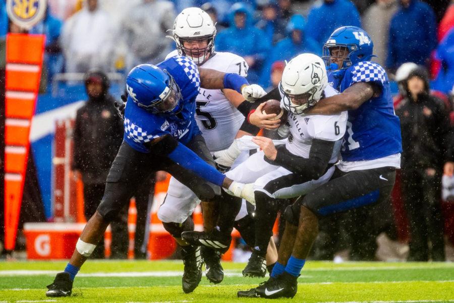 UK’s defense brings down UofL’s quarterback during the University of Kentucky vs. University of Louisville Governor’s Cup football game on Saturday, Nov. 30, 2019, at Kroger Field in Lexington, Kentucky. UK won 45-13. Photo by Michael Clubb | Staff