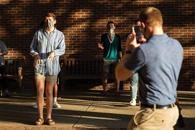 Senior vocal performance major Ben Boutell is filmed by doctoral candi- date Will Chandler for a TikTok during an acoUstiKats practice on Wednes- day, Oct. 7, 2020, at the University of Kentucky in Lexington, Kentucky. Photo by Michael Clubb.