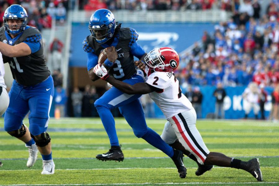 Kentucky Wildcats quarterback Terry Wilson (3) trying to break a tackle. University of Kentucky football lost to No. 6 Georgia 34-17 at Kroger Field on Saturday, November 3, in Lexington, Kentucky. Photo by Michael Clubb | Staff