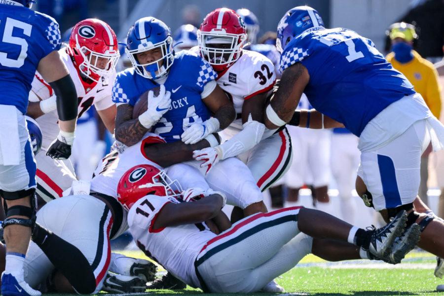 Kentucky Wildcats running back Chris Rodriguez Jr. (24) is tackled by a host of UGA defensive players during the University of Kentucky vs. University of Georgia football game on Saturday, Oct. 31, 2020, at Kroger Field in Lexington, Kentucky. UK lost 14-3. Photo by Michael Clubb | Staff
