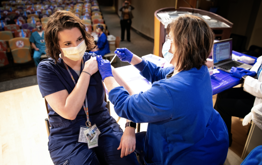 Abby Bailey,  Emergency medicine pharmacist gets her vaccination from UK Health services nurse Janie Lawson, RN, as  UK administered its first round of Covid-19 vaccine on December 15, 2020. Photo by Mark Cornelison | UKphoto