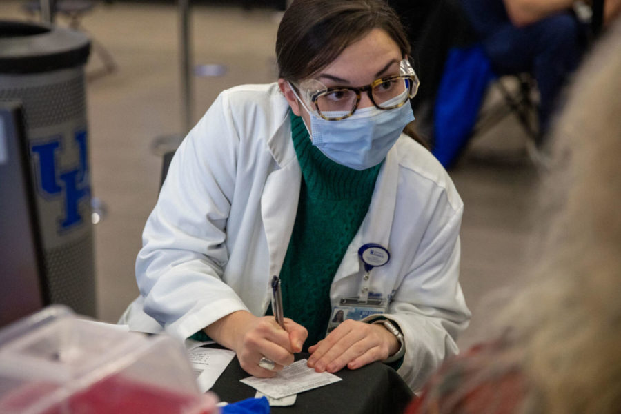 Rebecca Edwins, a third-year medical student, confirms a patients medical information at UK’s COVID-19 vaccination clinic on Saturday, Jan. 30, 2021, at Kroger Field in Lexington, Kentucky. Photo by Jack Weaver | Staff