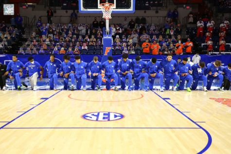 Members of Kentuckys mens basketball team kneel during the national anthem on Saturday at Florida. 