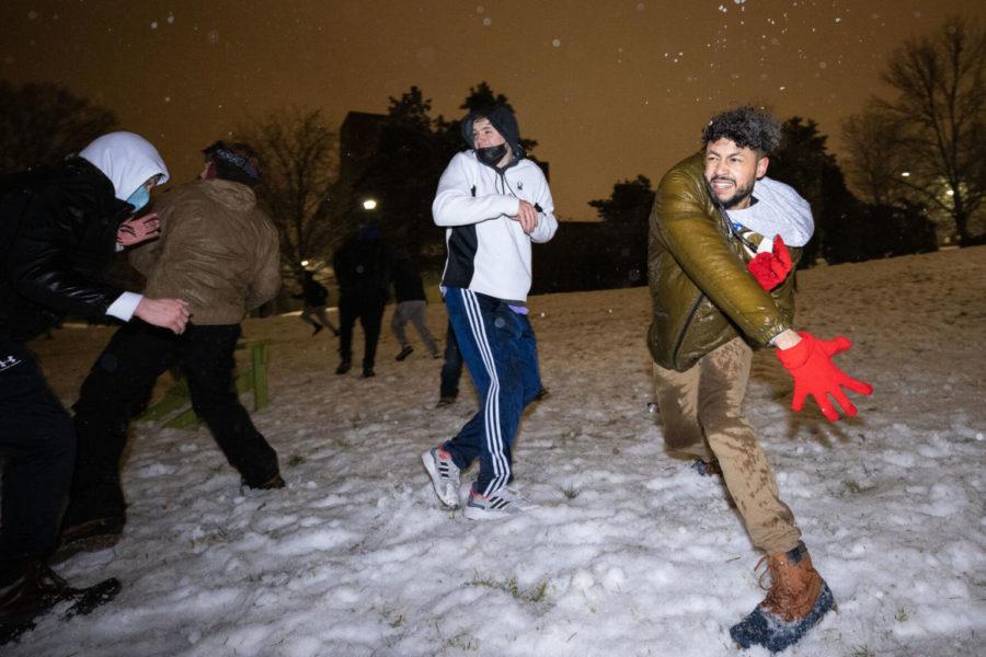 A UK student throws a snowball at The Bowl on Monday, Feb. 15, 2021, at William T. Young Library in Lexington, Kentucky. Photo by Michael Clubb | Staff