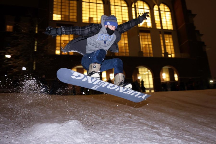 Freshman mechanical engineering major Blake Neace jumps a ramp on his snowboard at The Bowl at William T. Young Library on Thursday, Feb. 18, 2021 in Lexington, Kentucky. Photo by Michael Clubb | Staff