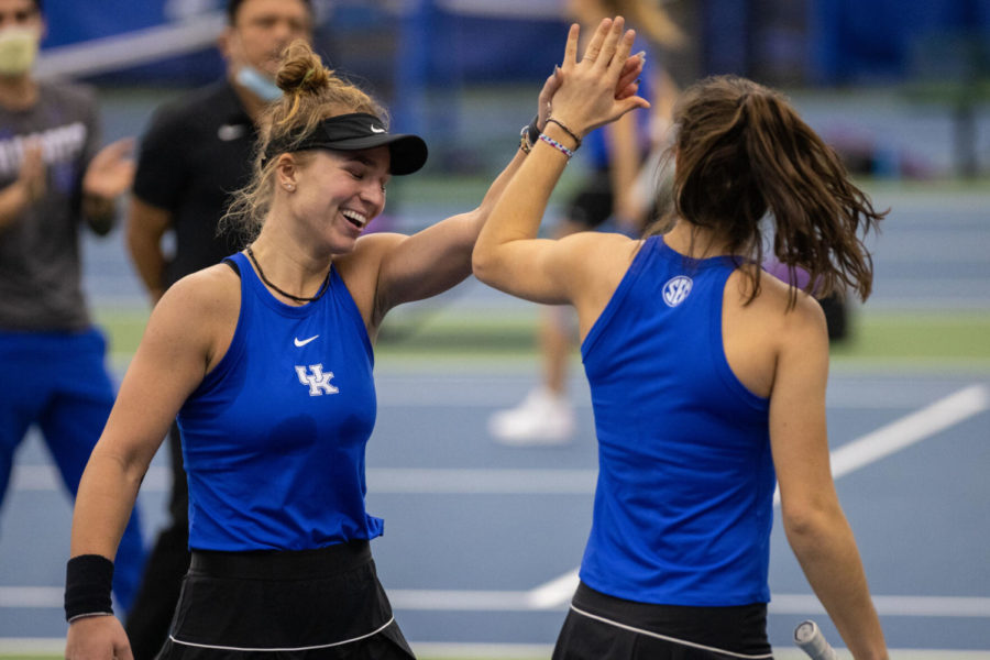 Akvile Parazinskaite high fives Carlota Molina after winning a point during the University of Kentucky vs. Louisiana State womens tennis meet on Saturday, Feb. 20, 2021, at the Hillary J. Boone Tennis Complex in Lexington, Kentucky. UK lost 4-3. Photo by Michael Clubb | Staff