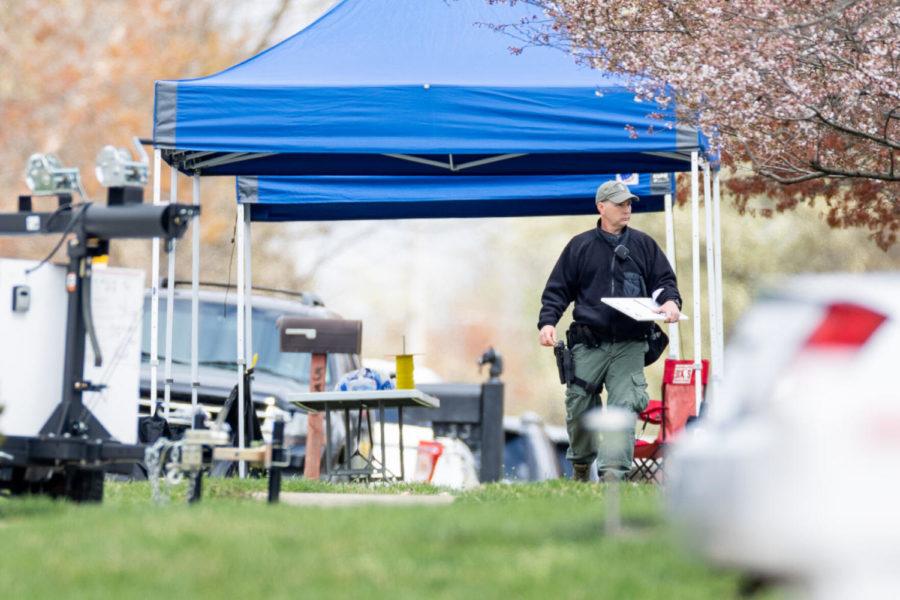 A law enforcement official walks through the scene of the investigation on Friday, March 26, 2021, at Bryan Carrolls home in Versailles, Kentucky. Photo by Jack Weaver | Staff