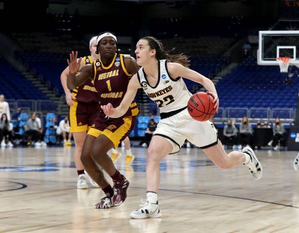Iowa Hawkeyes guard Caitlin Clark (22) drives against Central Michigan Chippewas guard Micaela Kelly (1) in the first round of the 2021 NCAA Womens Basketball Tournament Sunday, March 21, 2021 in San Antonio, Tx.Image - and caption (assumed) - by Stephen Mally of hawkeyesports.comhttps://hawkeyesports.com/news/2021/03/21/photos-iowa-womens-basketball-vs-central-michigan-ncaa-tournament-round-1/