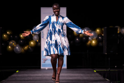 A model walks down the runway during the Black History Fashion Show on Friday, Feb. 26, 2021, at the Gatton Student Center in Lexington, Kentucky. Photo by Michael Clubb | Staff
