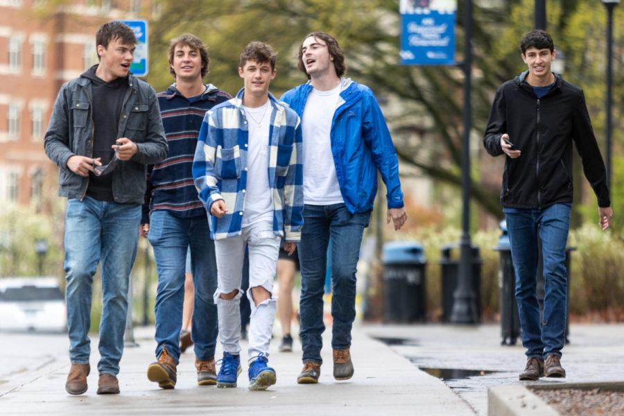A group of unmasked students walk towards The 90 on Saturday, April 10, 2021, at the University of Kentucky in Lexington, Kentucky. Photo by Jack Weaver | Staff