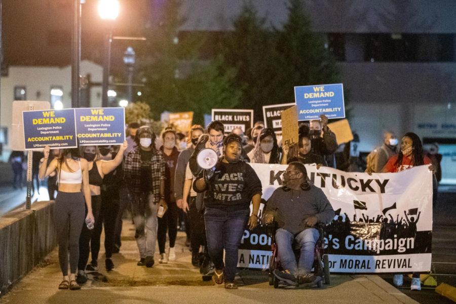 Protesters march down the sidewalk during a protest in response to the grand jury decision on the Breonna Taylor case on Wednesday, Sept. 23, 2020, in Lexington, Kentucky. Photo by Michael Clubb | Staff