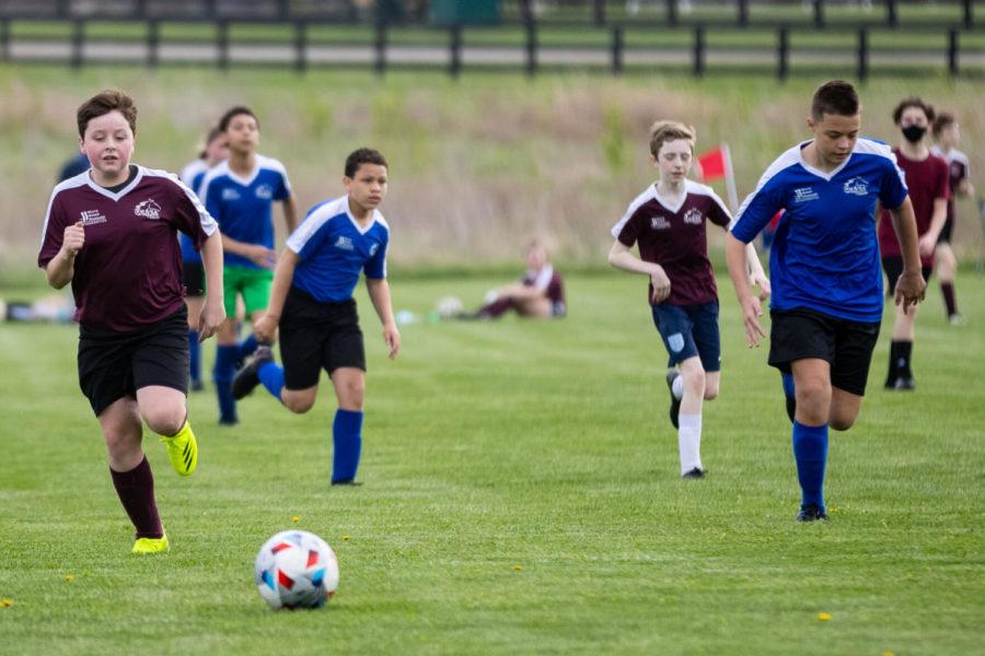 Players chase after a ball during a Lexington Youth Soccer Association game on Saturday, April 10, 2021, at Masterson Station Park in Lexington, Kentucky. Photo by Michael Clubb | Staff
