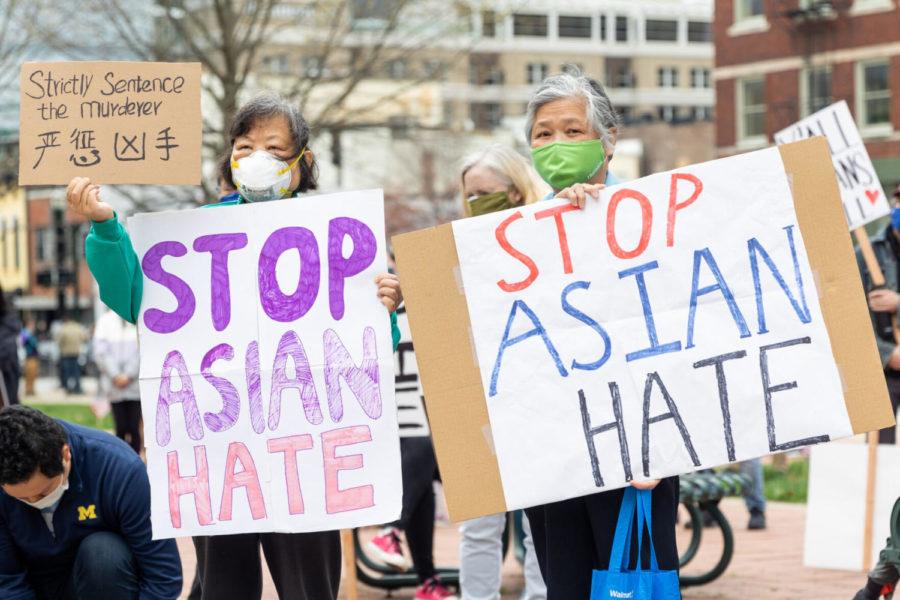 A pair of demonstrators holds signs during a rally to condemn violence against Asian Americans on Saturday, March 27, 2021, outside Robert Stephens Courthouse in Lexington, Kentucky. Photo by Jack Weaver | Staff