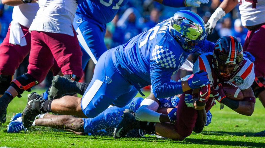 Kentucky nose tackle Quinton Bohanna tackles a Virginia Tech player during the Belk Bowl against Virginia Tech on Tuesday, Dec. 31, 2019, at Bank of America Stadium in Charlotte, North Carolina. Kentucky won 37-30. Photo by Jordan Prather | Staff