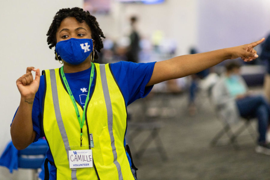 Camille Wright, a junior ISC and digital media design major, directs patients to open stations on Saturday, April 10, 2021, at UK’s COVID-19 vaccination clinic at Kroger Field in Lexington, Kentucky. Photo by Jack Weaver | Staff
