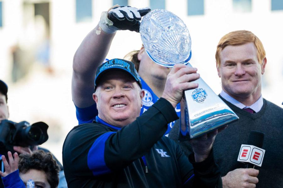 Kentucky Wildcats head coach Mark Stoops holds up the Belk Bowl trophy after the Belk Bowl football game between Kentucky and Virginia Tech on Tuesday, Dec. 31, 2019, at Bank of America Stadium in Charlotte, North Carolina. UK won 37-30. Photo by Michael Clubb | Staff