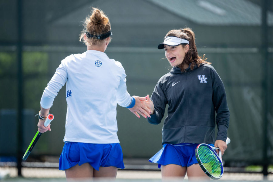 Fiona Arrese high fives Akvilė Paražinskaitė after scoring a point during the University of Kentucky vs. Tennessee women’s tennis match on Sunday, March 28, 2021, at Hillary J. Boone Tennis Center in Lexington, Kentucky. Photo by Michael Clubb | Staff