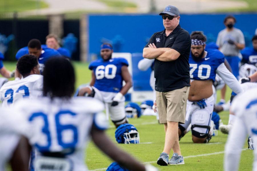 Kentucky head coach Mark Stoops watches his players warm up during an open practice in Lexington, Ky., Tuesday, Aug. 17, 2021. (AP Photo/Michael Clubb)
