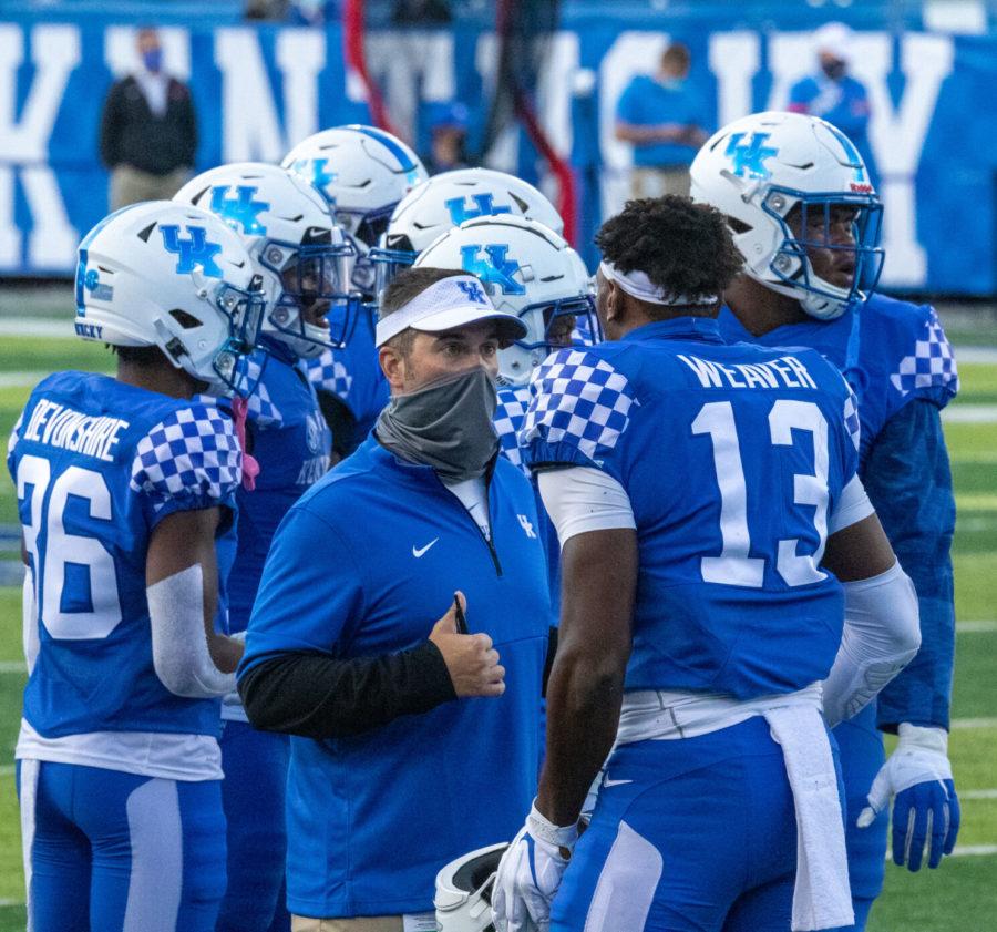 UK defensive coordinator Brad White pulls J.J Weaver (13) to the side side during a timeout to discuss the play at hand during the University of Kentucky vs Ole Miss football game on Saturday, Oct. 3, 2020, at Kroger Field in Lexington, Kentucky. UK lost 41-42. Photo by Victoria Rogers | Staff