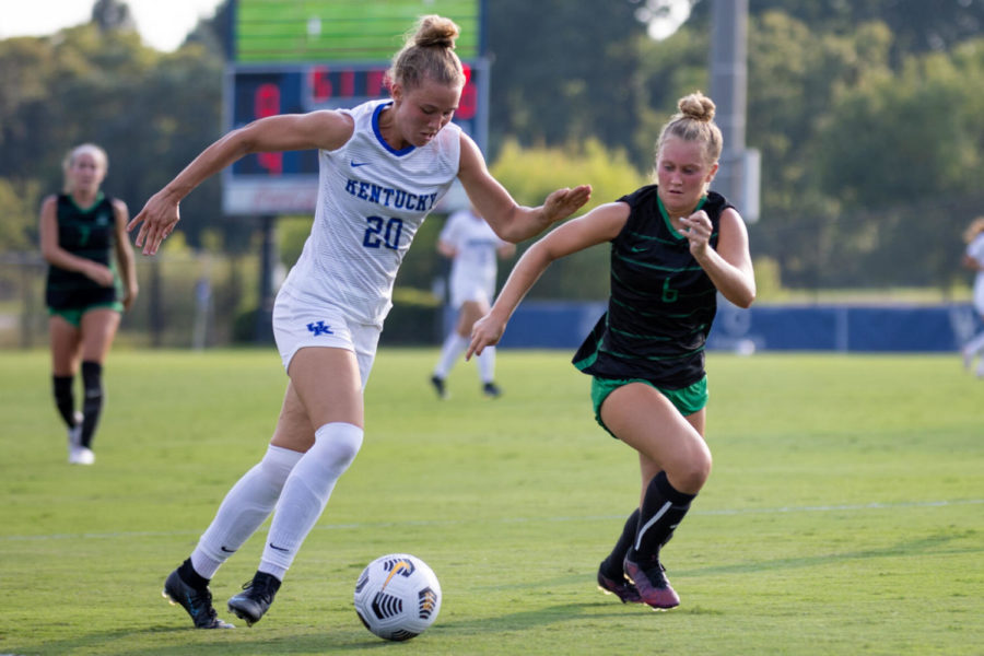 Kentucky+Wildcats+midfielder+%C3%9Alfa+%C3%9Alfarsd%C3%B3ttir+%2820%29+dribbles+past+a+defender+during+UK%E2%80%99s+game+against+Marshall+on+Sunday%2C+Aug.+22%2C+2021%2C+at+Wendell+and+Vickie+Bell+Soccer+Complex+in+Lexington%2C+Kentucky.+UK+won+3-0.+Photo+by+Jack+Weaver