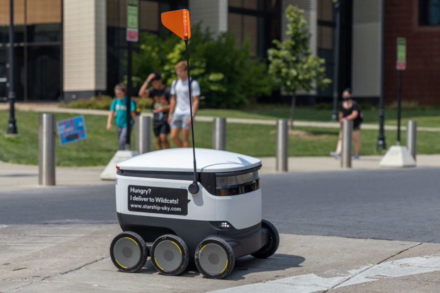 A Starship robot crosses Hilltop Avenue in front of the Jacobs Science Building on Wednesday, Aug. 25, 2021, at the University of Kentucky in Lexington, Kentucky. Photo by Jack Weaver | Staff