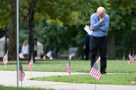A man remembers the fallen victims of 9/11. UK Army and Air Force ROTC placed nearly 3,000 flags this morning in front of the administration building and had speakers read out the names of fallen victims of the terrorism attacks of September 11th, 2001 on Tuesday, September 11, 2018 in Lexington, Kentucky. Photo by Michael Clubb | Staff