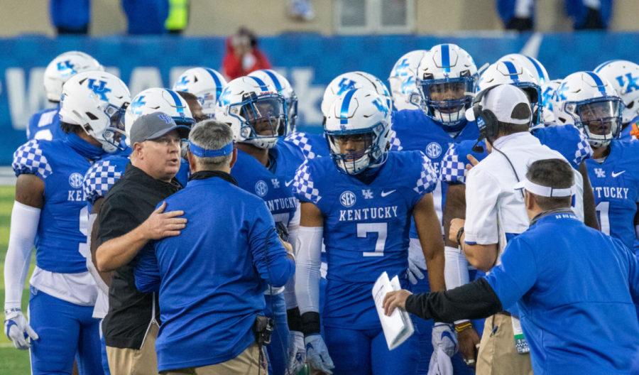 UK head coach Mark Stoops and huddles up the Kentucky defense during the University of Kentucky vs Ole Miss football game on Saturday, Oct. 3, 2020, at Kroger Field in Lexington, Kentucky. UK lost 41-42. Photo by Victoria Rogers | Staff