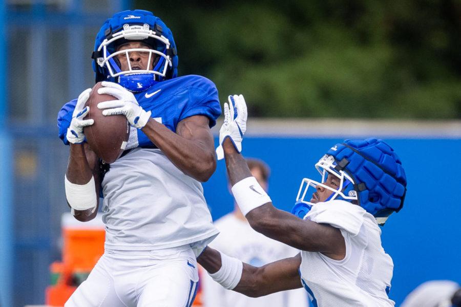 Kentucky wide receiver Isaiah Epps (81) catches a pass guarded by Kentucky defensive back Cedrick Dort Jr. (3) during an open practice in Lexington, Ky., Tuesday, Aug. 17, 2021. (AP Photo/Michael Clubb)
