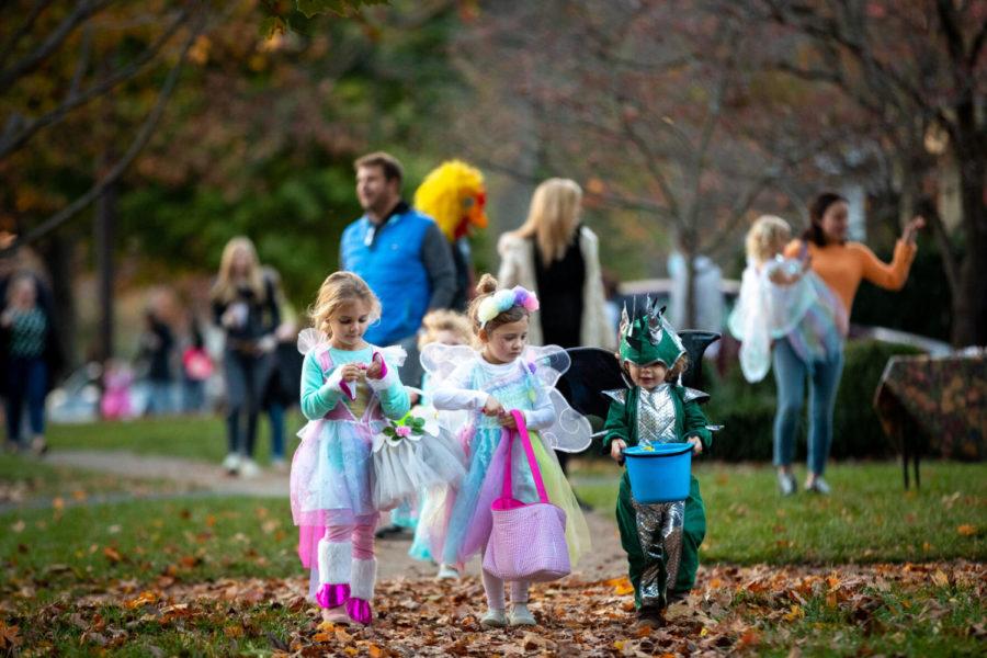 Young trick or treater walk down the sidewalk with their candy during Halloween on Saturday, Oct. 31, 2020, on Chenault Rd in Lexington, Kentucky. Photo by Michael Clubb | Staff.