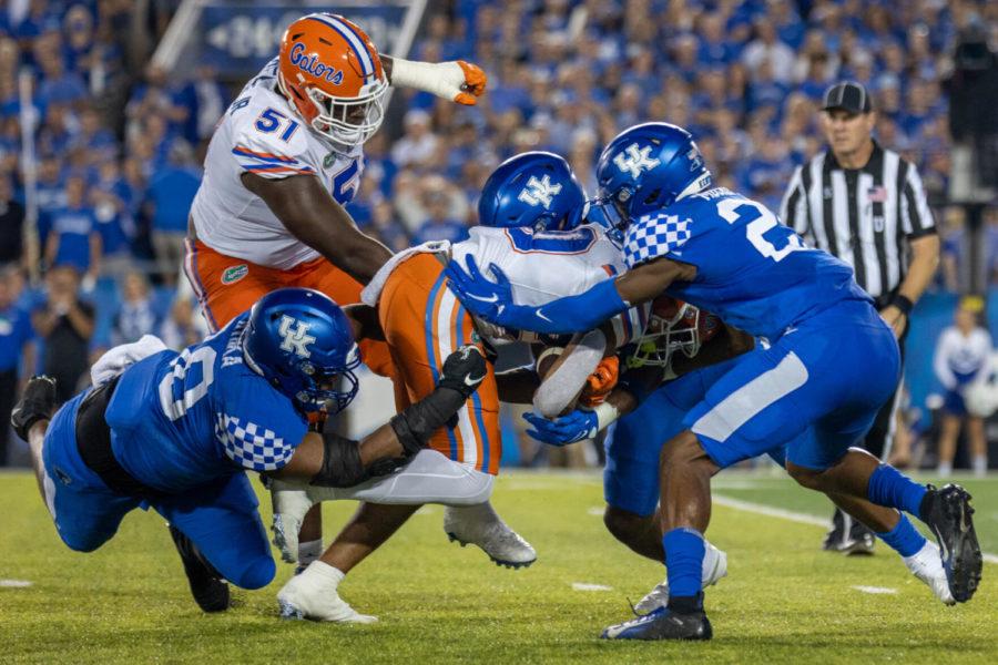 A group of Wildcats makes a tackle during the University of Kentucky vs. Florida football game on Saturday, Oct. 2, 2021, at Kroger Field in Lexington, Kentucky. UK won 20-13. Photo by Jack Weaver | Staff