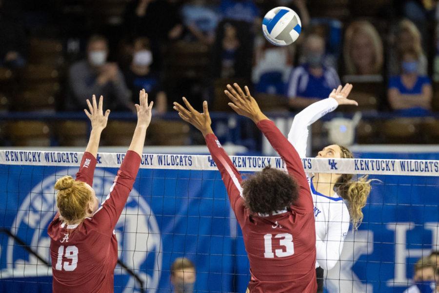 Kentucky Wildcats middle blocker Bella Bell (14) hits the ball during the University of Kentucky vs. University of Alabama volleyball game on Wednesday, March 24, 2021, at Memorial Coliseum in Lexington, Kentucky. UK won 3-0. Photo by Michael Clubb | Staff