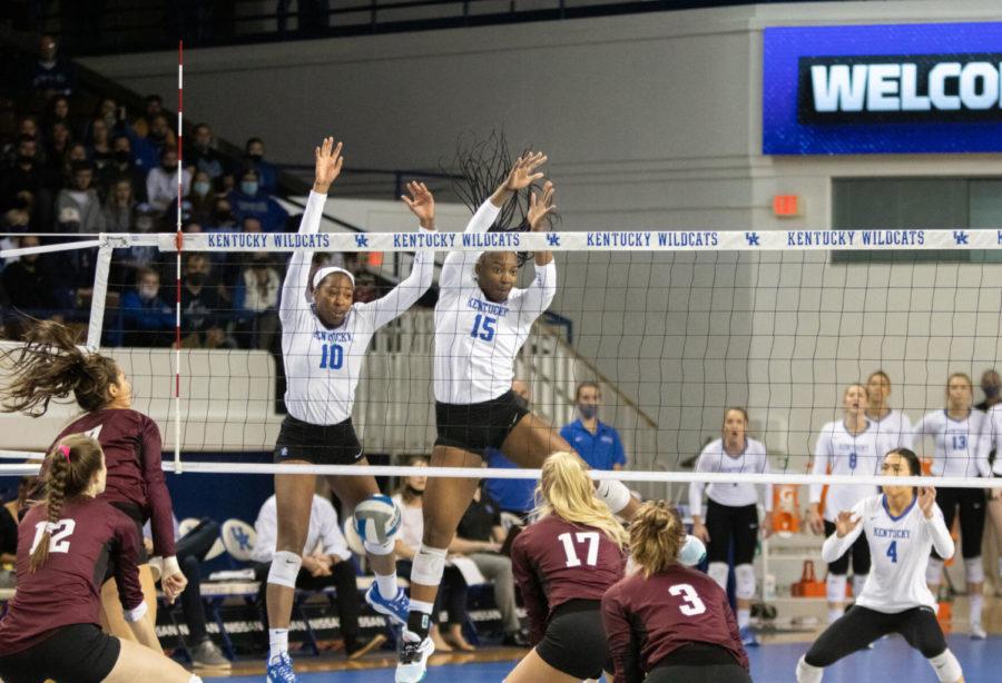Kentucky Wildcats opposite Reagan Rutherford (10) and Kentucky Wildcats middle blocker Azhani Tealer (15) jump up to block the ball during the UK vs. Texas A&M volleyball game on Saturday, Nov. 13, 2021, at Memorial Coliseum in Lexington, Kentucky. UK won 3-0. Photo by Amanda Braman | Staff