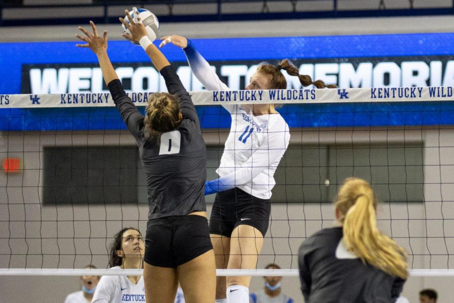 Kentucky Wildcats middle blocker Elise Goetzinger (11) hits the ball over the net during the University of Kentucky vs. Missouri volleyball game on Friday, Sept. 24, 2021, at Memorial Coliseum in Lexington, Kentucky. UK won 3-0. Photo by Jack Weaver | Staff